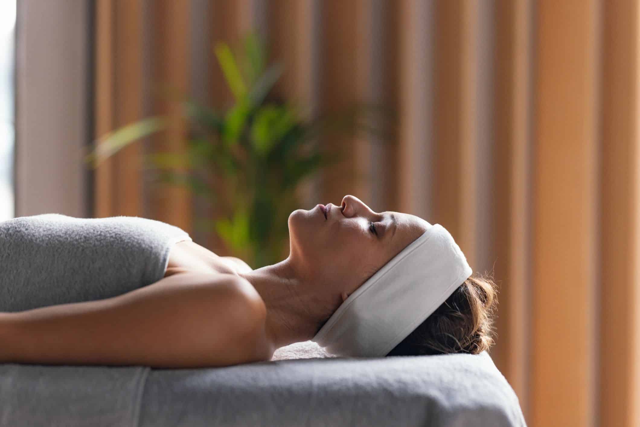 Client relaxing after a facial treatment at a spa